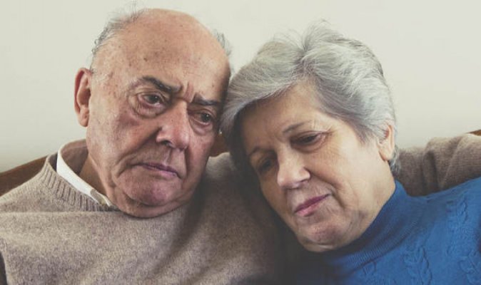 elderly-couple-looking-sad-586005