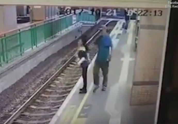 TRENUTAK HORORA: Muškarac gurnuo ženu na prugu (VIDEO)