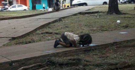 OVA FOTOGRAFIJA JE POSRAMILA SVIJET: Siromašna devojčica pije vodu iz bare na zemlji (FOTO)