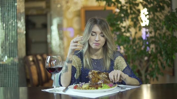 videoblocks-young-attractive-tattooed-blond-girl-in-fancy-dinner-restaurant-licking-greasy-fingers-inappropriate-behaviour-in-public-ruod5a9cz-thumbnail-full01