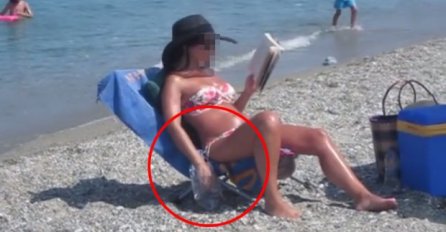 SJEDILA JE NA PLAŽI, NAMAZANA ULJEM I ČITALA KNJIGU, A SVI SU VIDJELI ONO OGAVNO ŠTO JE RADILA: "Mora da je Srpkinja" (VIDEO)