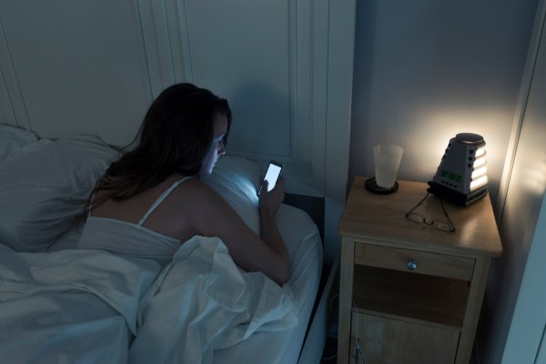 woman-checking-cellphone-messages-in-bed