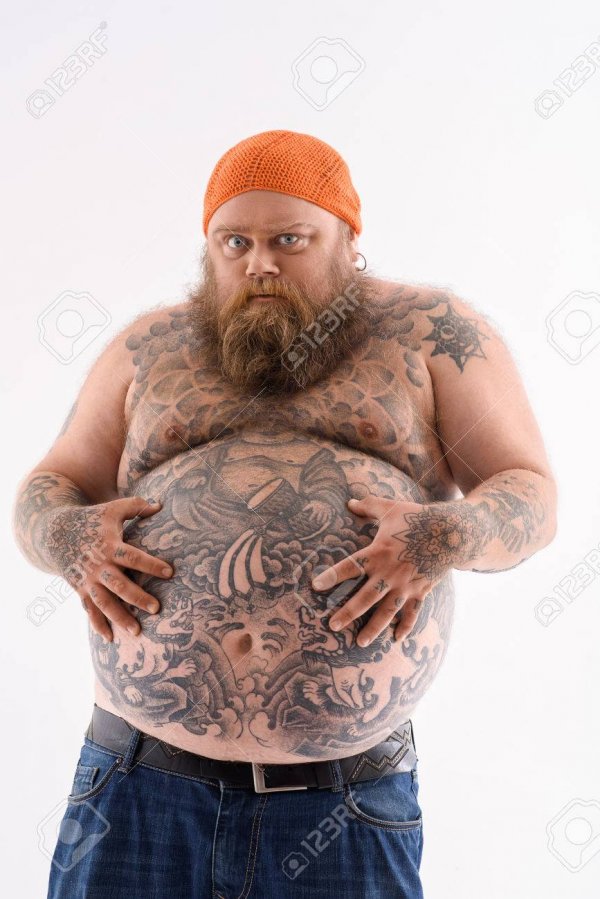 61178617-i-am-very-hungry-fat-man-is-touching-his-naked-belly-with-tattoo-he-is-standing-and-looking-forward
