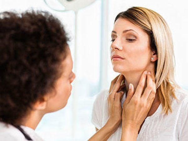 woman-getting-thyroid-exam-article