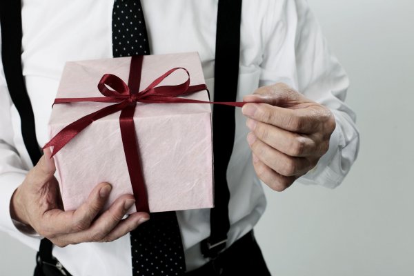 old-age-businessman-pulling-a-ribbon-of-the-gift-royalty-free-image-1607448419