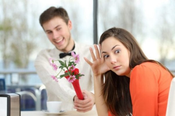 disgusted-woman-rejecting-man-giving-her-flowers