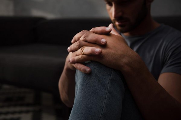 stock-photo-sad-man-sitting-floor-home