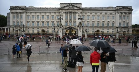 Građani pristižu i ispred Buckinghamske palače u Londonu, čekaju vijesti na kiši